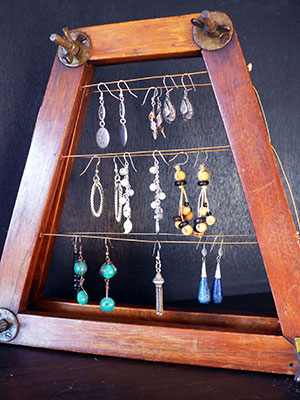 Tennis racket frame repurposed as a Jewellery Holder